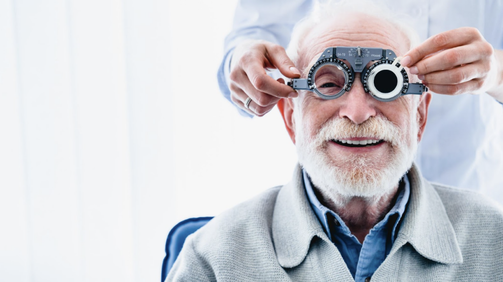 A happy smiling senior man having his eyes tested for diseases during a comprehensive eye exam.
